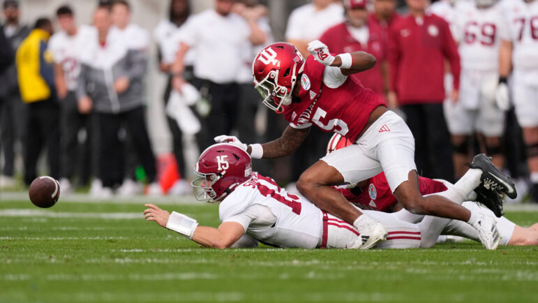 Alabama quarterback Ty Simpson fumbles as he is hit by Indiana defensive back D'Angelo Ponds.