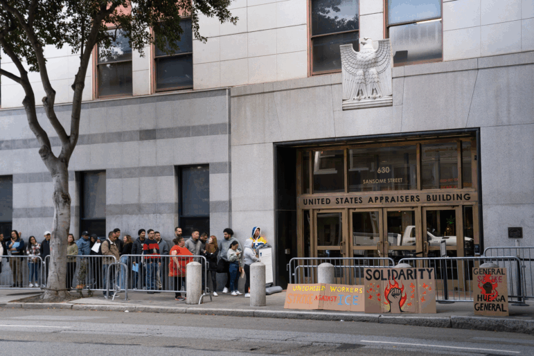 People wait outside immigration court in October 2025 in San Francisco.