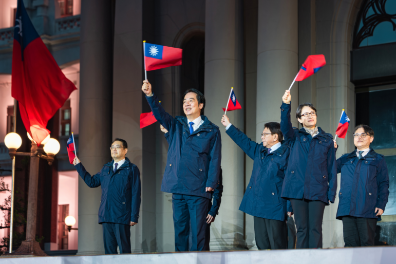 In this photo released by the Taiwan Presidential Office, Taiwanese President Lai Ching-te (center) is accompanied by his Vice President Bi-Khim Hsiao (second right) and officials wave national flags as they attend a New Year flag raising ceremony at the Presidential Office, in Taipei, Taiwan, on Thursday, Jan. 1.