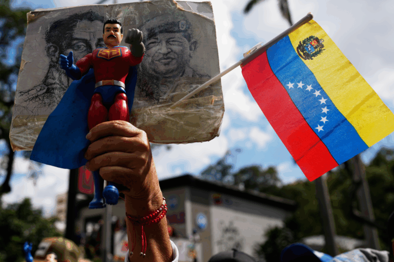 A government supporter holds an action figure of Super Bigote during a protest demanding the release of President Nicolas Maduro, who was captired by U.S. forces, in Caracas, Venezuela, Sunday, Jan. 4.