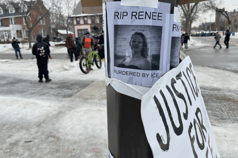 A makeshift memorial honoring Renee Good, who was fatally shot by an Immigration and Customs Enforcement agent, is taped to a post near the site of the previous day's shooting in Minneapolis.