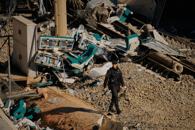 Guardia Civil officers collect evidence Tuesday next to the wreckage of train cars involved in a collision in Adamuz in southern Spain.