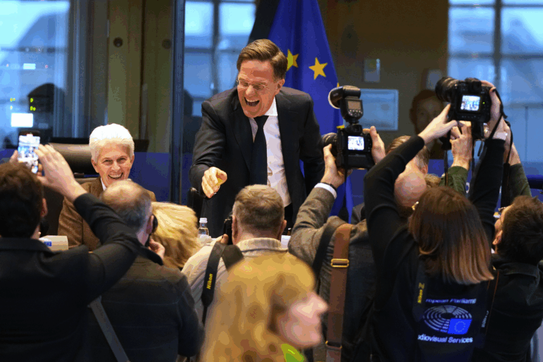 NATO Secretary General Mark Rutte, center, greets the audience prior to his address during the Security and Defence Committee at the European Parliament in Brussels, Monday, Jan. 26, 2026.