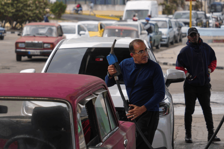 A driver refuels others wait in a long line behind to fill up at a gas station in Havana, Cuba, Tuesday, Jan. 27, 2026.