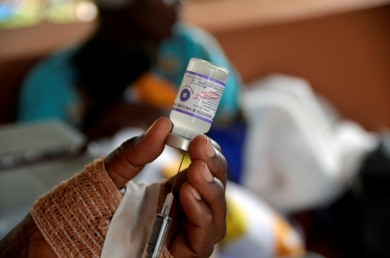 A medical worker prepares vaccine at a health center during the Hepatitis B vaccination exercise in Wakiso district, Central Region, Uganda, July 28, 2021. World Hepatitis Day takes place every year on July 28 to raise awareness of viral hepatitis.