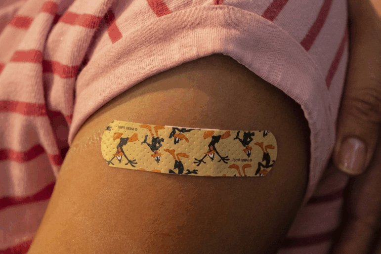 A bandage is seen on a child's arm after she received a COVID vaccine on November 3, 2021 in Shoreline, Washington.