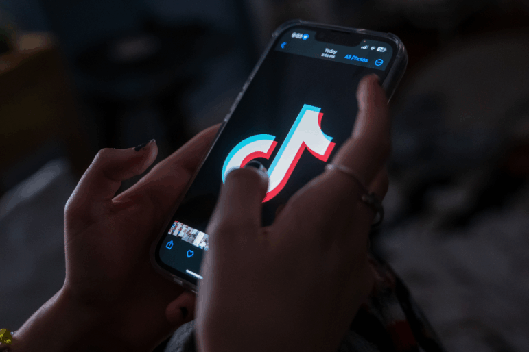 This photo illustration shows the hands of a teenager holding her mobile phone and using it to access TikTok on January 31, 2024, in New York City.