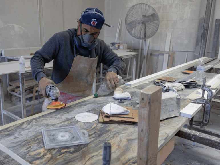 Sun Valley, CA: A stone countertop fabricator wears a mask to help protect against airborne particles which can contribute to silicosis at a shop in Sun Valley, CA. (Brian van der Brug / Los Angeles Times via Getty Images)
