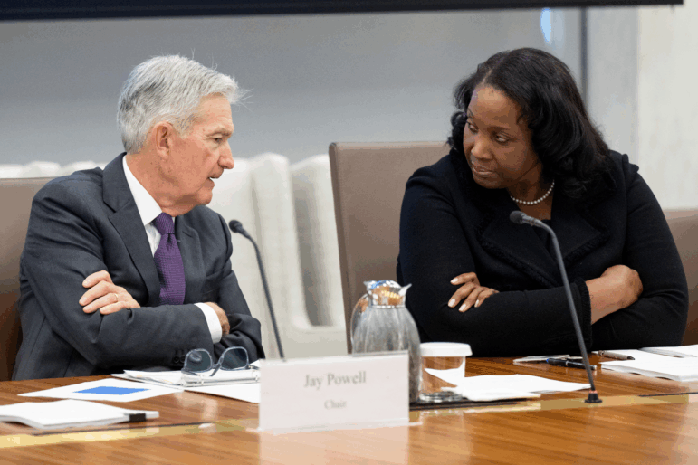 Fed Chair Jerome Powell speaks with Lisa Cook, a member of the Board of Governors of the Federal Reserve, during a meeting in Washington on June 25.