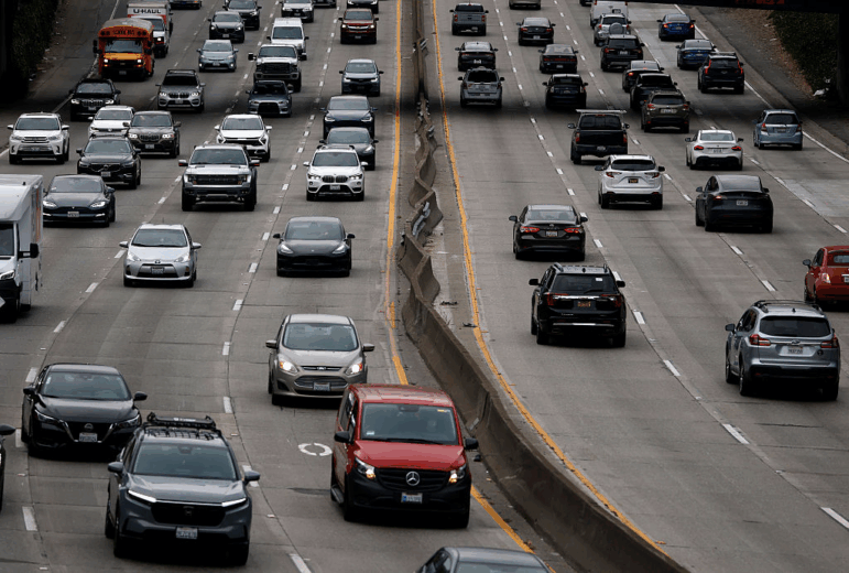 Cars drive on an 8-lane freeway in San Francisco, Ca.