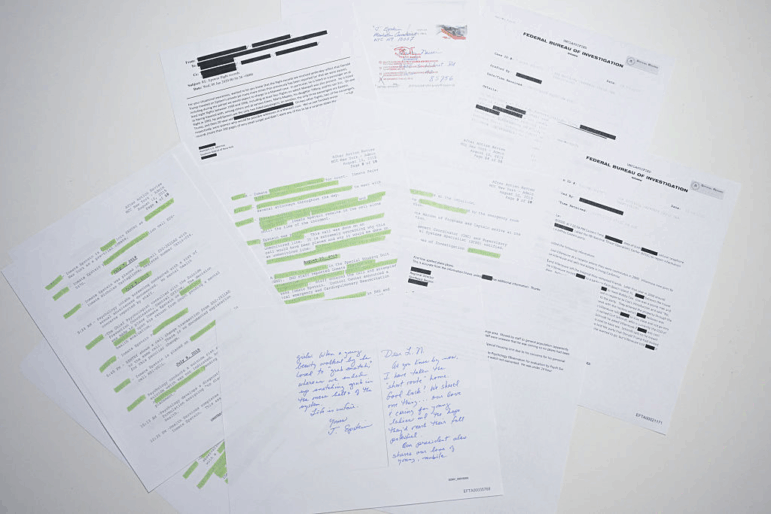 This photo illustration shows a new batch of files released in December by the U.S. government in relation to the late sex offender Jeffrey Epstein. A first batch was made public December 19, 2025 amid fierce criticism that the US Justice Department was deliberately slow-walking the release and excluding any references to US President Donald Trump. The latest slew of documents contains 8,000 files, including hundreds of videos or audio recordings. This includes surveillance footage from August 2019, the month Epstein was found dead in his jail cell -- and declared to have committed suicide. (Photo by AFP via Getty Images)