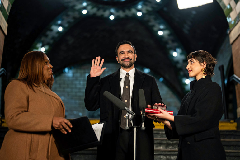 Zohran Mamdani is sworn in as New York City's 112th mayor by New York Attorney General Letitia James, left, alongside his wife Rama Duwaji, right, in the former City Hall subway station on January 1, 2026 in New York City.