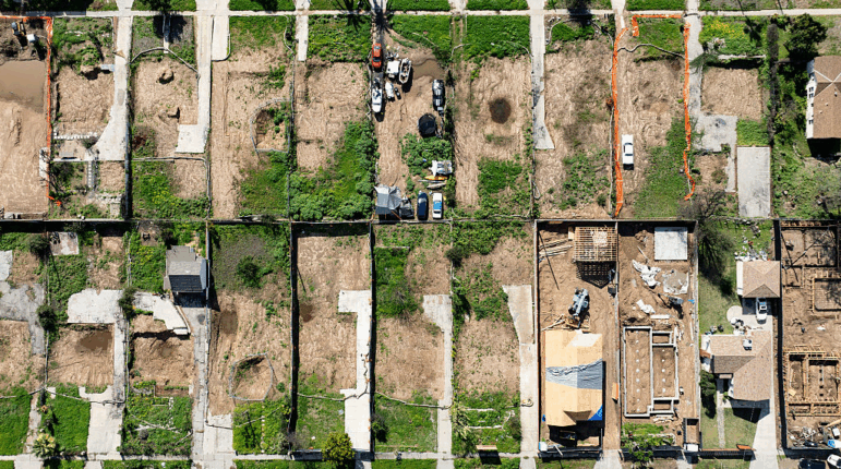 An aerial view shows empty lots and new homes under construction in Altadena, California on January 5, 2026. Altadena was hardest hit by the fires that ravaged parts of the sprawling US metropolis in January 2025. Thousands of homes were destroyed and 19 people died in the town -- compared to 12 killed in the upscale Pacific Palisades neighborhood. (Photo by JOSH EDELSON / AFP via Getty Images)