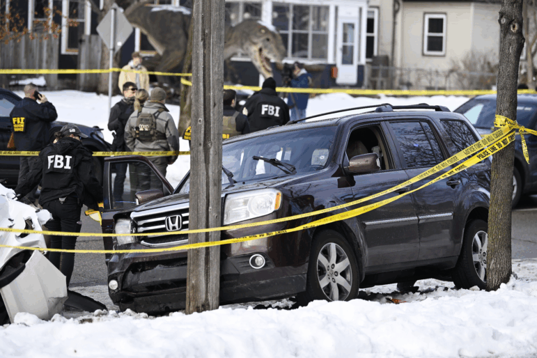 Members of law enforcement work the scene following a suspected shooting by an ICE agent during federal law enforcement operations on Wednesday in Minneapolis.