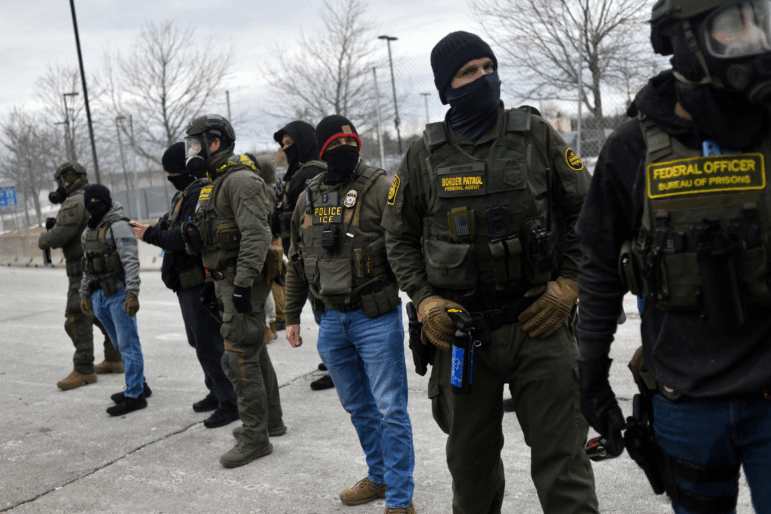 Federal law enforcement agents confront protesters during a demonstration outside the Bishop Whipple Federal Building in Minneapolis, Minnesota, on Thursday.