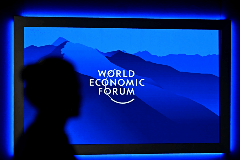 The logo of the World Economic Forum is displayed on a big screen as a visitor is silhouetted during the World Economic Forum (WEF) annual meeting in Davos on Jan. 20.