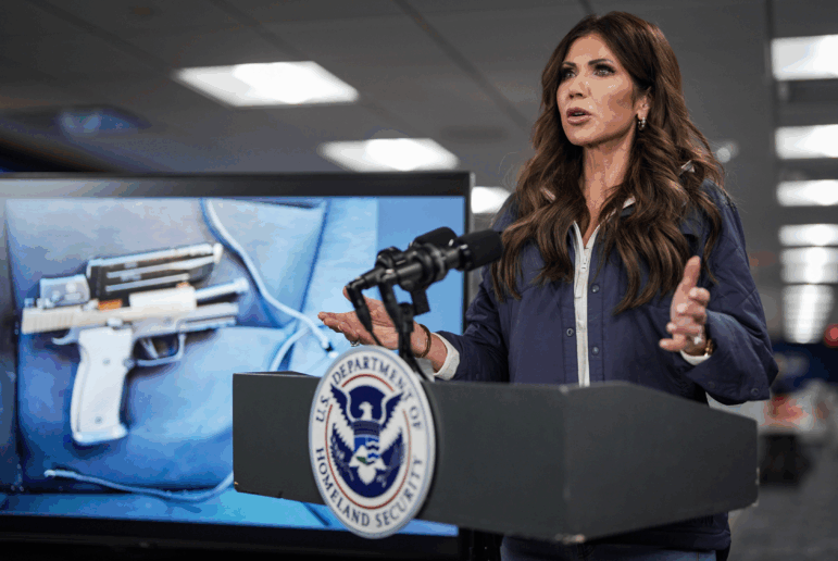 A photograph of the pistol recovered by immigration agents after a shooting in Minneapolis is shown on a screen behind U.S. Secretary of Homeland Security Kristi Noem as she speaks during a news conference in Washington, D.C., on Jan. 24. Federal immigration agents shot and killed Alex Pretti that day during operations in Minneapolis.