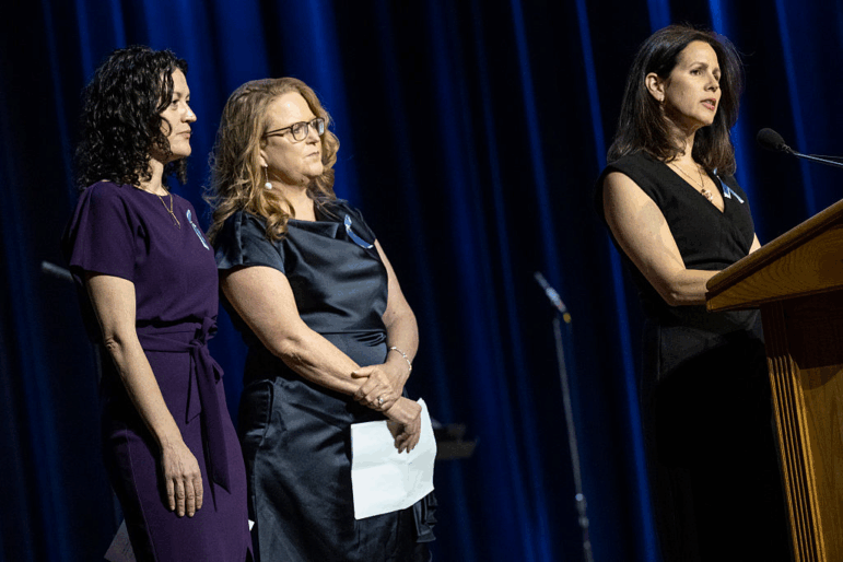 Rachel Feres (left) and other family members speak at a memorial event at DAR Constitution Hall in Washington, D.C. for the 67 people who were killed in the midair collision of a U.S. Army helicopter and an American Airlines regional jet a year ago.
