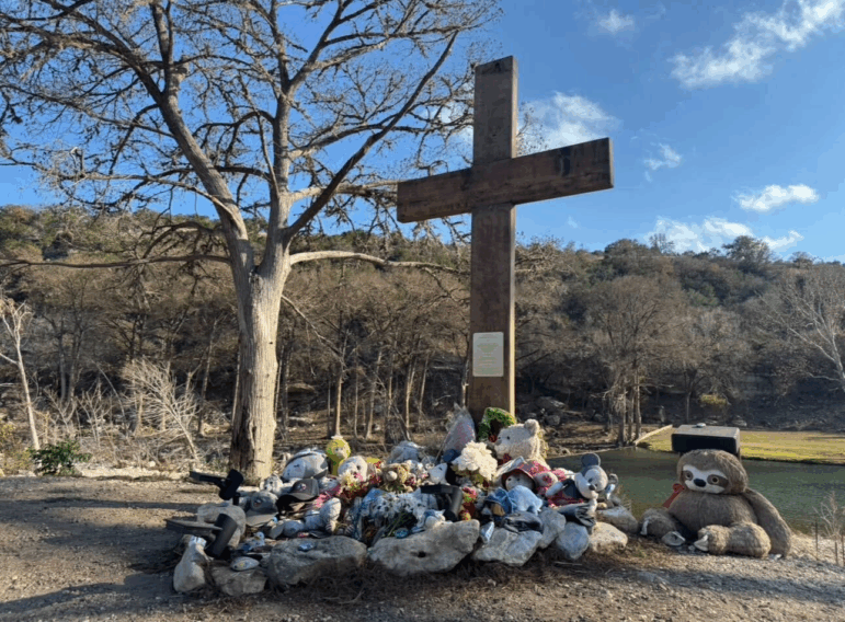 Stuffed animals and flowers surround a memorial outside Camp Mystic, along the Guadalupe River near Kerrville, Texas, honoring the nearly 30 children who were killed when floodwaters tore through the area on July 4.