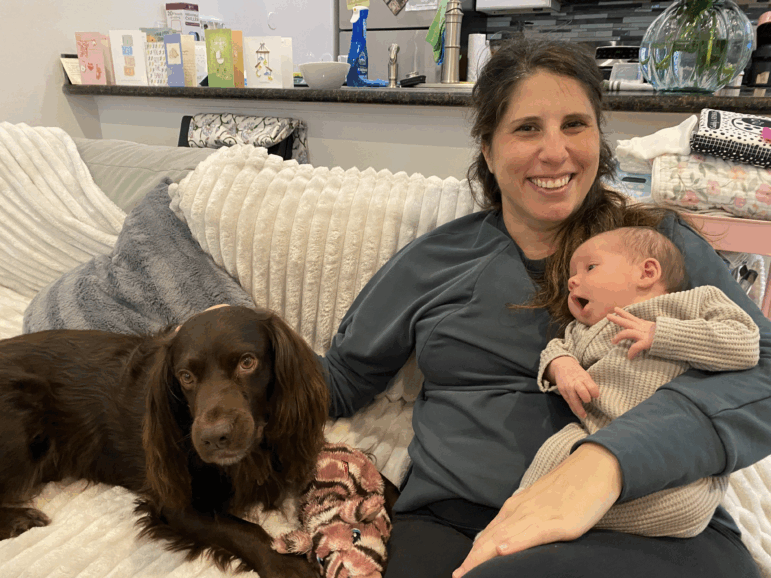 Lisa Bonfield cradles her newborn daughter, Adele, at her home in New Orleans on Dec. 12, a few days after their first home visit from a nurse with the Family Connects program.