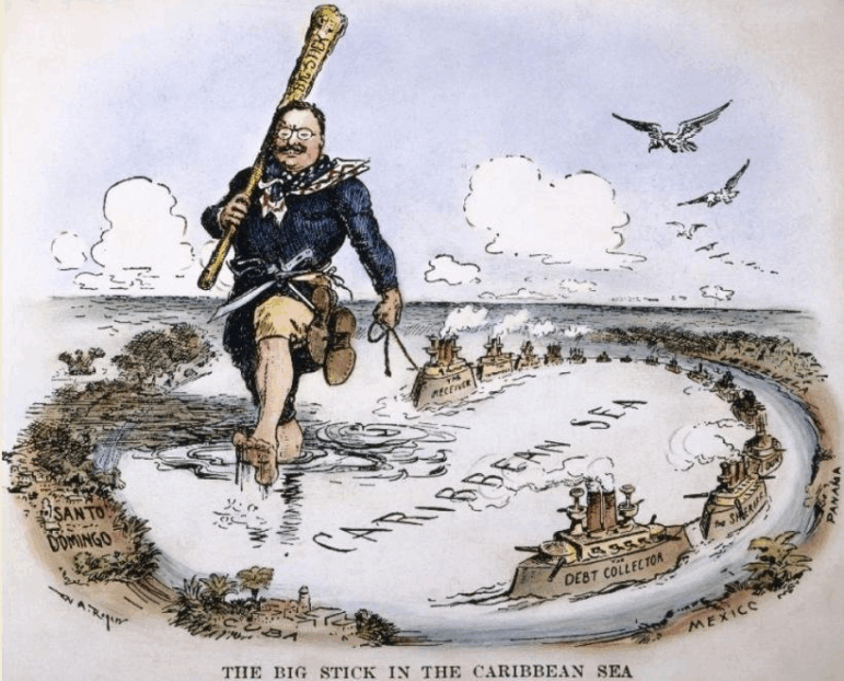In this political cartoon, a giant President Theodore Roosevelt is walking in the Caribbean Sea and carrying a big club over his shoulder. One hand is holding onto a string that's connected to a chain of ships that are floating in the Caribbean.