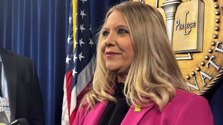 Republican State Sen. April Weaver speaks to reporters at the Alabama Statehouse in Montgomery.