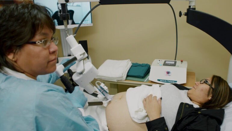 Technician Shawna Piche assists patient Trina Lobillard as she receives a remotely controlled ultrasound in 2018 in Stony Rapids, Saskatchewan.