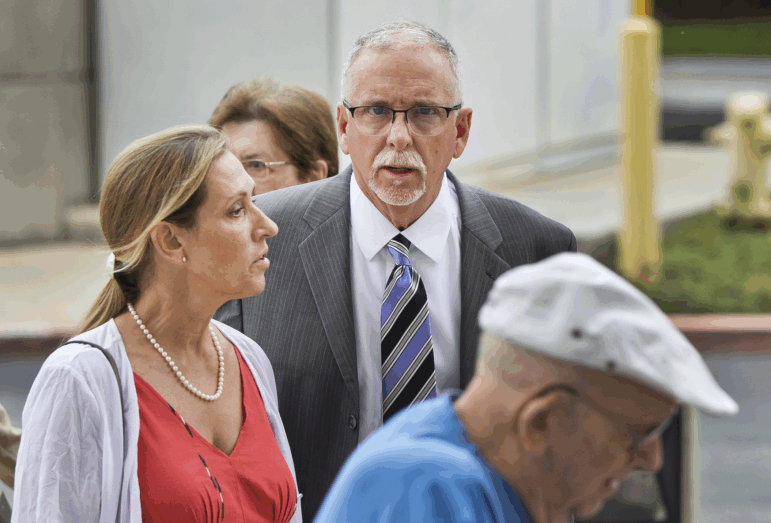 FILE - In this June 26, 2019 file photo UCLA gynecologist James Heaps, center, and his wife, Deborah Heaps, arrive at Los Angeles Superior Court. Nine more women have alleged in two lawsuits they were sexually assaulted by the former gynecologist who worked for the University of California, Los Angeles. The lawsuits say the women were groped, fondled and penetrated digitally by Dr. James Heaps during examinations between 1989 and 2017.