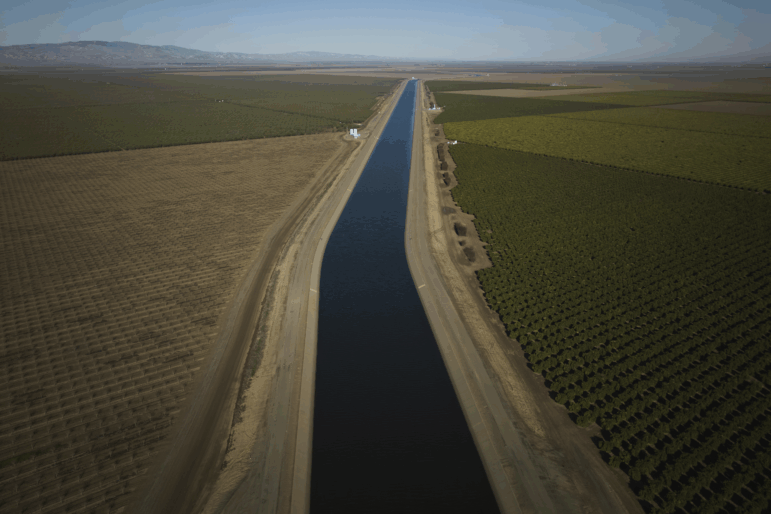 The San Luis Canal flows alongside farmland in Huron, Calif., Saturday, March 8, 2025. Some farmers in the region are leaving land fallow because water is increasingly scarce.