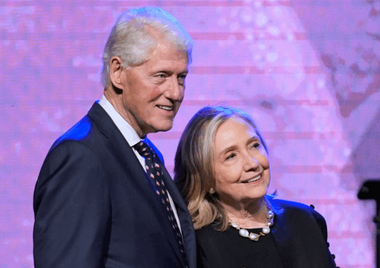 FILE - Former President Bill Clinton, left, and former Secretary of State Hillary Clinton listen as Vice President Kamala Harris delivers a eulogy for U.S. Rep. Sheila Jackson Lee, Aug. 1, 2024, in Houston.