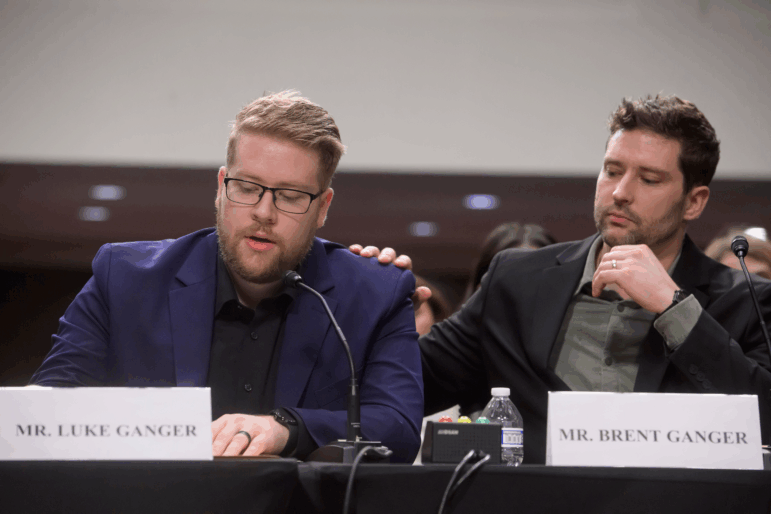 Luke Ganger, left, and Brent Ganger, right, brothers of Renee Good, appear during a Bicameral Public Forum on the Disproportionate Use of Force by DHS Agents, on Capitol Hill, Tuesday, Feb. 3, 2026, in Washington.