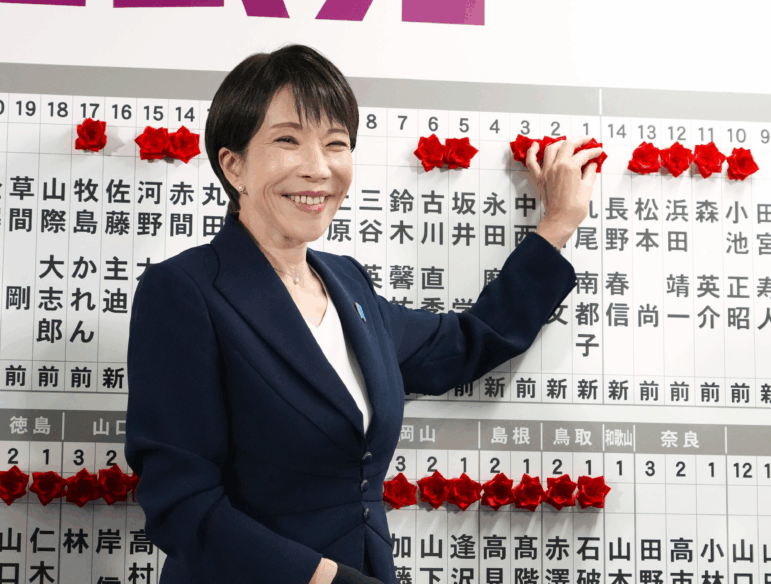 Sanae Takaichi, Japan's prime minister and president of the ruling Liberal Democratic Party (LDP), puts pins marking the names of candidates who won lower house elections at the LDP headquarters Sunday, Feb. 8, 2026 in Tokyo.