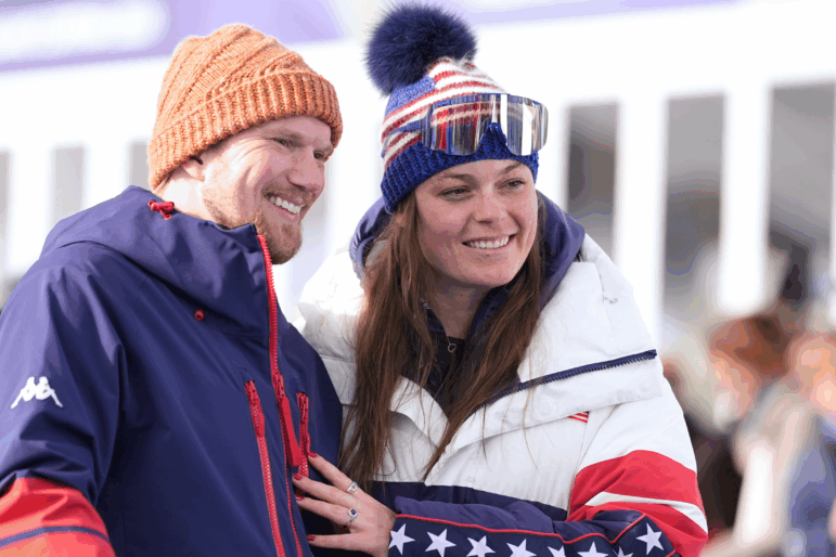 United States' Breezy Johnson, right, and fiancee Connor Watkins are interviewed after he proposed to her at the end of an alpine ski, women's super-G race, at the 2026 Winter Olympics, in Cortina d'Ampezzo, Italy, Thursday, Feb. 12, 2026.