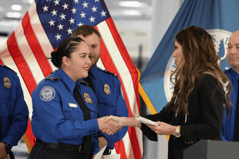 FILE - U.S. Homeland Security Secretary Kristi Noem, right, shakes hands with Transportation Security Administration Officer Monica Degro at a news conference at Harry Reid International Airport, Nov. 22, 2025, in Las Vegas.