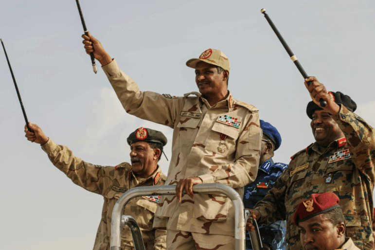 Gen. Mohammed Hamdan Dagalo, center, greets the crowd during a military-backed tribes' rally in the Nile River State of Sudan, on Saturday, July 13, 2019.