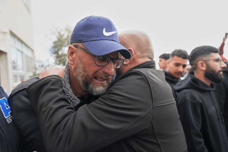 Mourners give condolences to Mohammad Abu Siyam, the father of Palestinian-American Nasrallah Abu Siyam, 19, who according to the Palestinian Health Ministry was shot by settlers on Wednesday night, during his funeral in the West Bank village of Mukhmas, east of Ramallah, Thursday, Feb. 19, 2026. (AP Photo/Nasser Nasser)