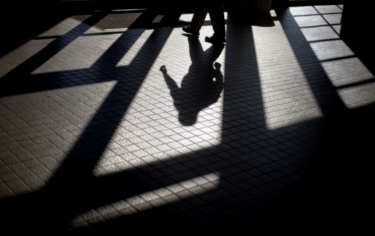 In this 2012 photo, the shadow of a Georgia Department of Juvenile Justice correctional officer is cast as he leaves a training facility.