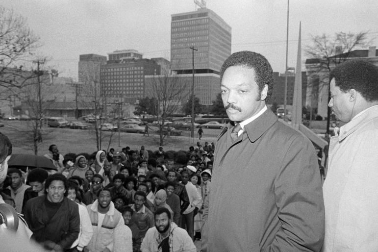 The Rev. Jesse Jackson stands on the steps of the Hinds county courthouse in Jackson, Mississippi, Tuesday, Jan. 17, 1984 after leading a large groups students and supporters from the Jackson State University campus to the Courthouse to register voters.