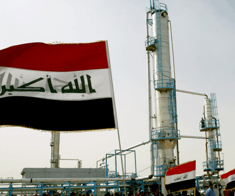 Iraqi flags flutter during the opening ceremony of a new oil refinery plant in the Shiite holy city of Najaf