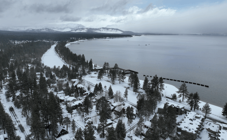 In an aerial view, snow covers the banks of Lake Tahoe on March 21, 2023 in South Lake Tahoe, California.