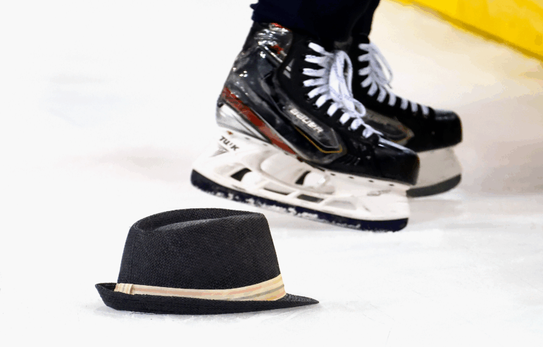 A hat tossed onto the hockey rink after a hat trick was scored.