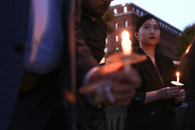 Hong Kong Democracy Council Executive Director Anna Kwok holds a candle as she participates during a candlelight vigil to mark the anniversary of the Tiananmen Square massacre on June 3, 2024 in Washington, DC.