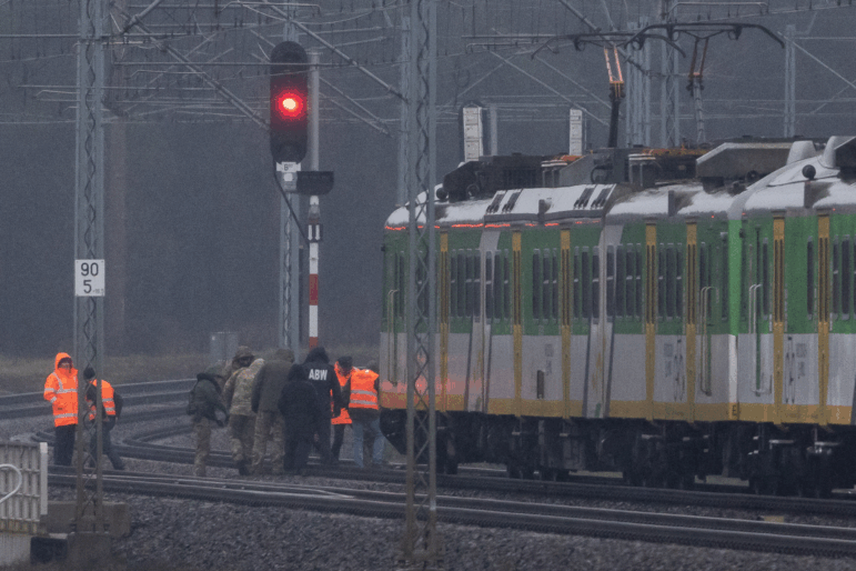 Investigators examine the railways damaged in an explosion on the rail line in Mika, next to Garwolin, central Poland