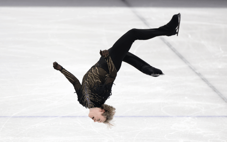 Ilia Malinin lands a backflip in his free skate in the team event on Sunday.
