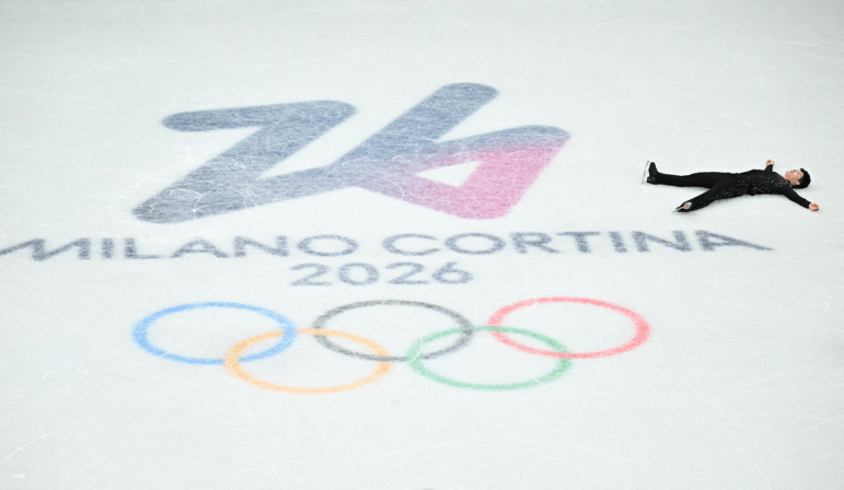 Figure skater Li Yu-Hsiang lies on his back on the ice.