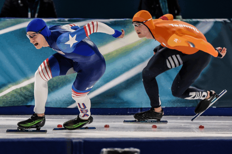 U.S. skater Jordan Stolz, right, and Netherlands skater Jenning de Boo race in the first lap of the Men's 500 final at Milano Speed Skate Stadium.