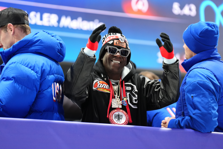 American rapper and television personality Flavor Flav watches on during the Women's Monobob Bobsleigh at the Cortina Sliding Centre, on Sunday February 15, 2026 at the Milano Cortina 2026 Winter Olympics, Italy.
