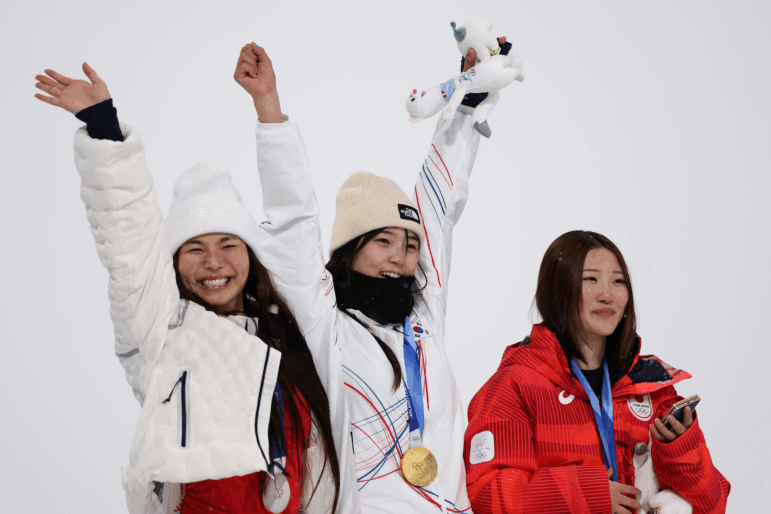 Chloe Kim (L), Gaon Choi (C) and Mitsuki Ono celebrate with their medals after the women's snowboard halfpipe event in Livigno, Italy on Thursday.