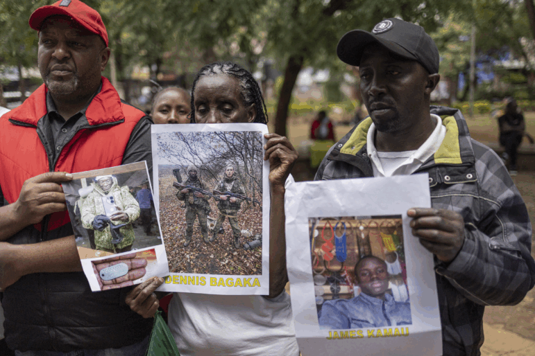 Relatives of Kenyan nationals conscripted by the Russian army in Ukraine pose with photos of their family members during a demonstration demanding urgent government action to repatriate their kin, in Nairobi on Feb.19, 2026.