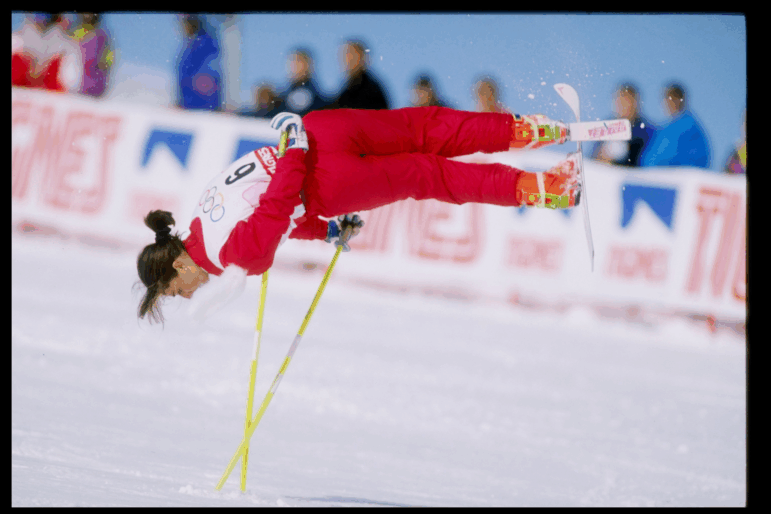 Cathy Fechoz of France, wearing a red ski suit, is caught midair while performing her routine during the ski ballet competition at the Olympic Games in Albertville, France, in 1992.